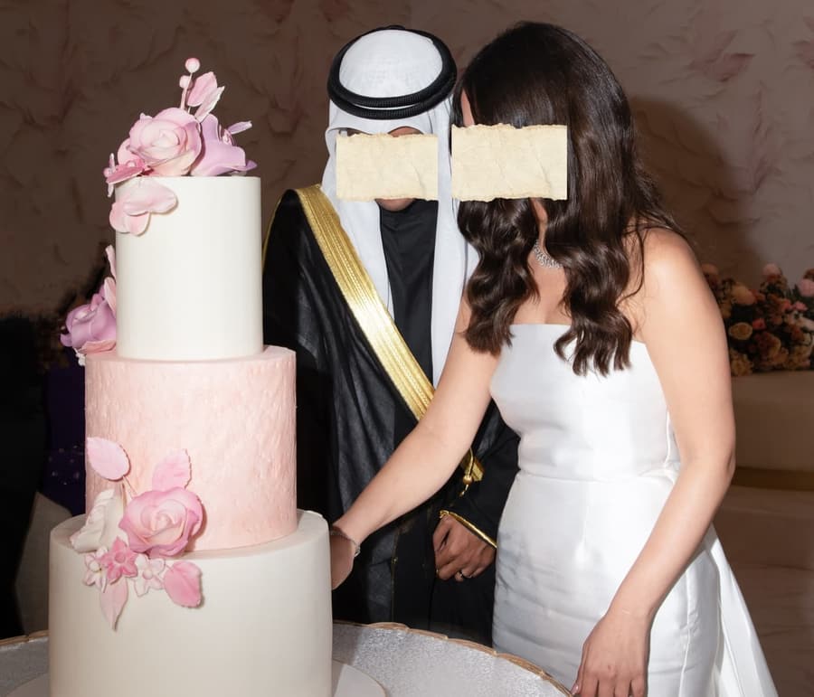 Bride and groom cutting a tiered wedding cake