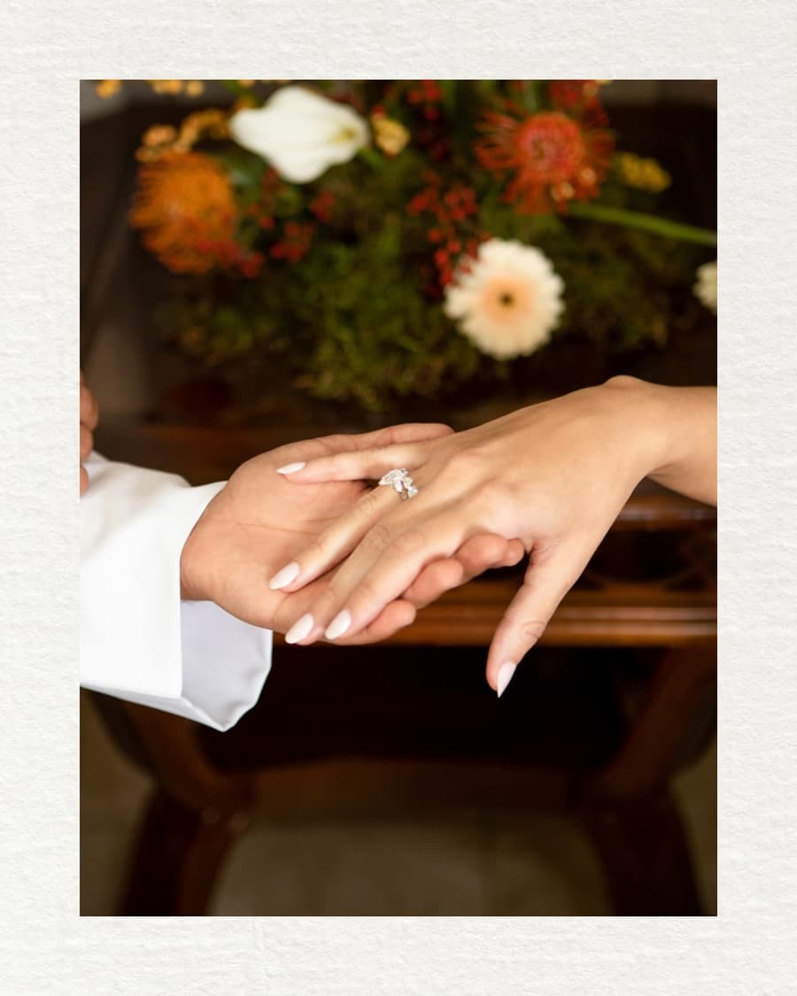 Wedding rings placed on intertwined hands